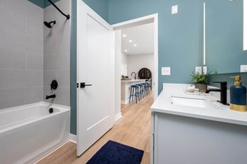 a bathroom with a bathtub and a sink  at Ironwood Flats, Brandon, 33511